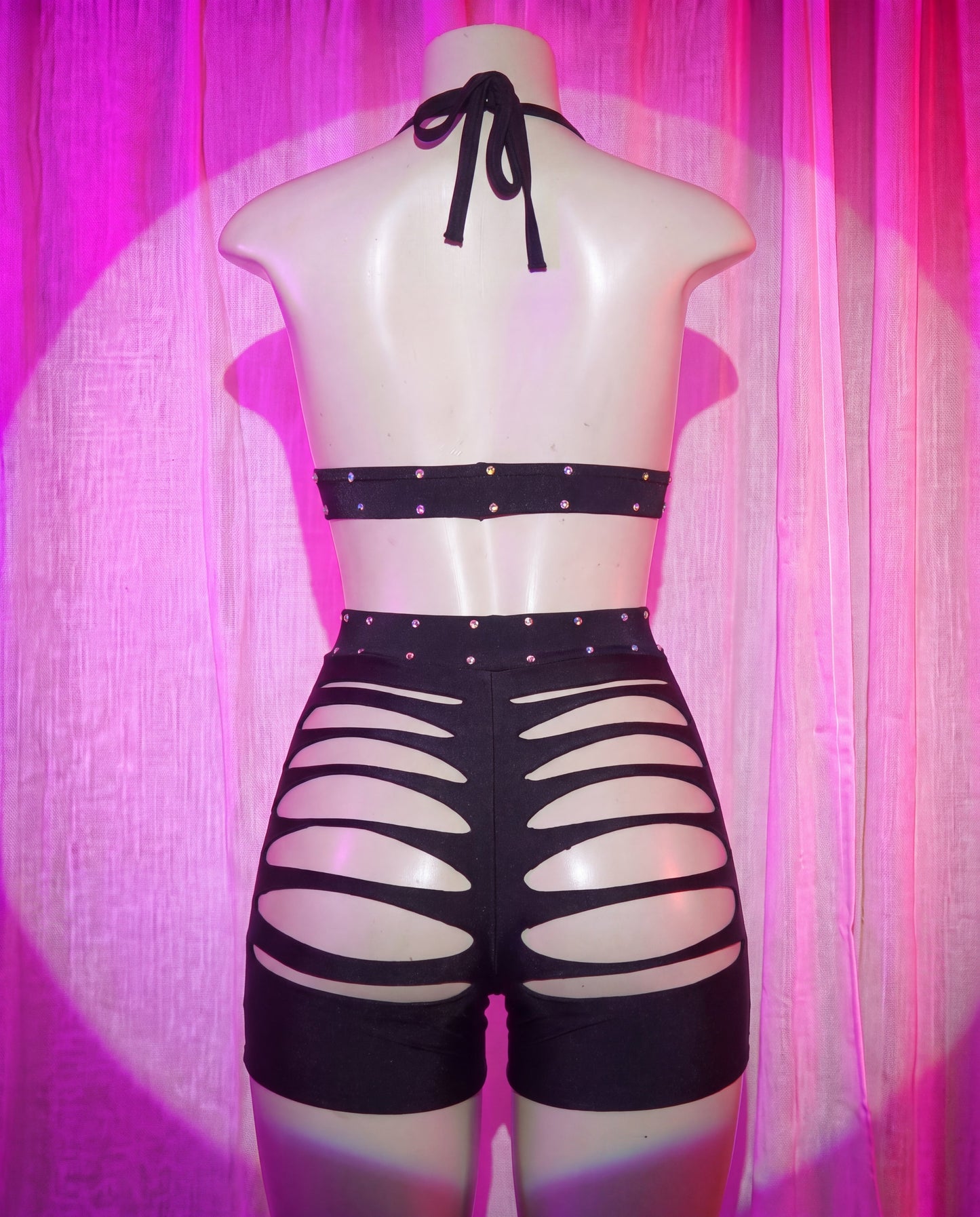 Back view of Starlet black rhinestone stripper shorts set with slashed detailing