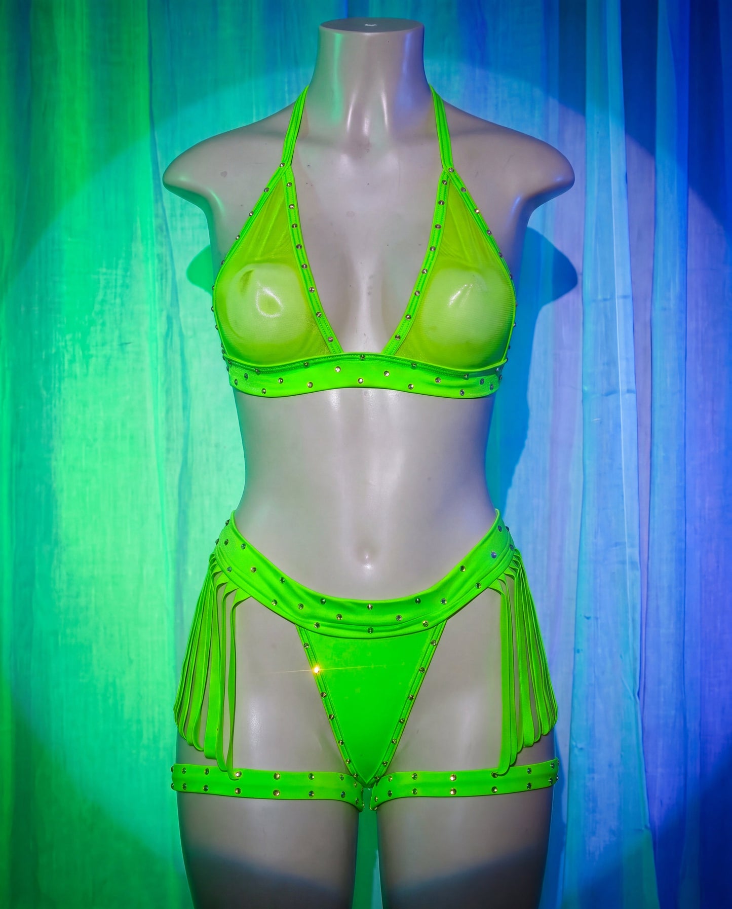 Front view of Storm green three-piece stripper lingerie set with fringe and garters