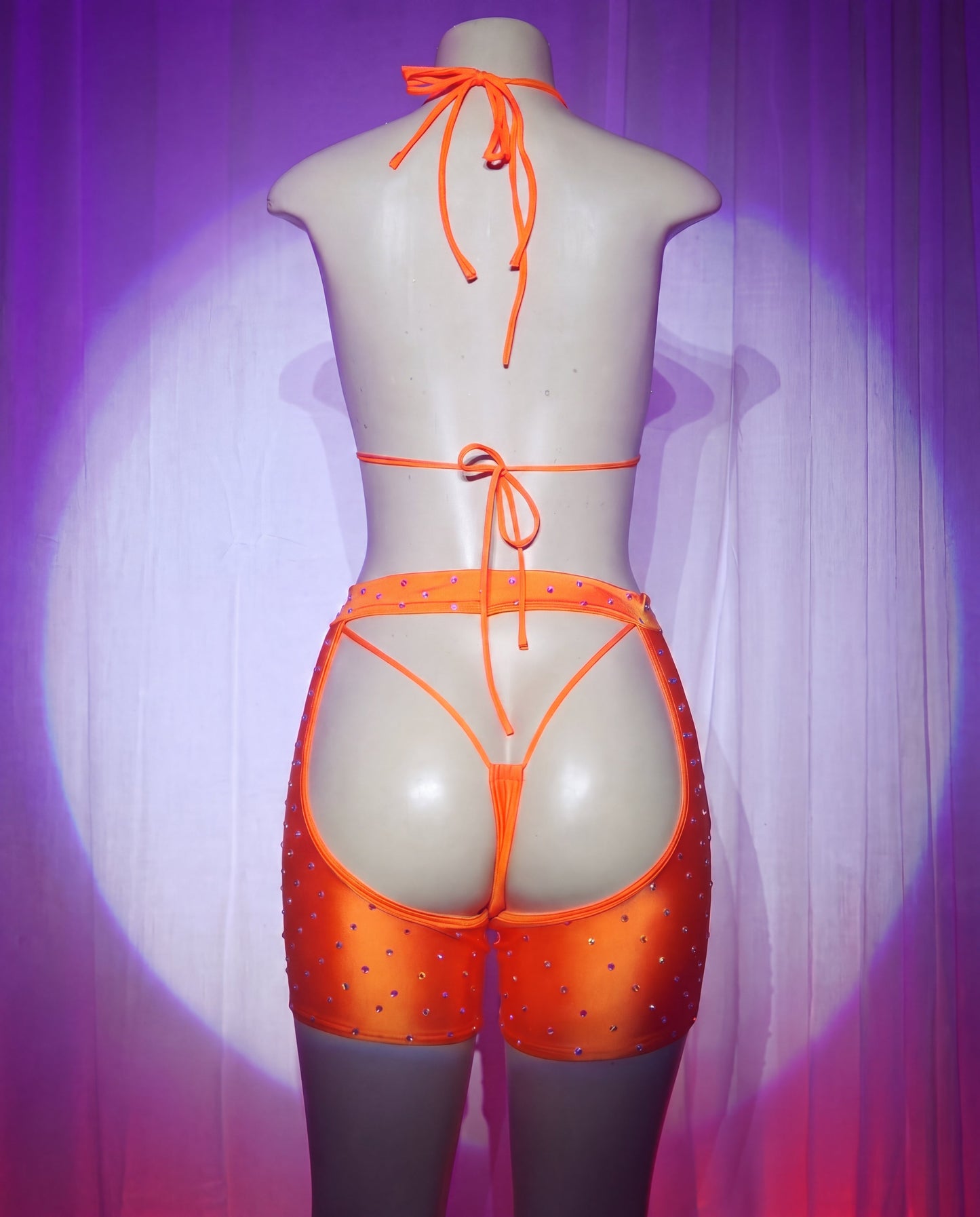 Back view of Rodeo orange rhinestone cowgirl stripper outfit with thong and chaps