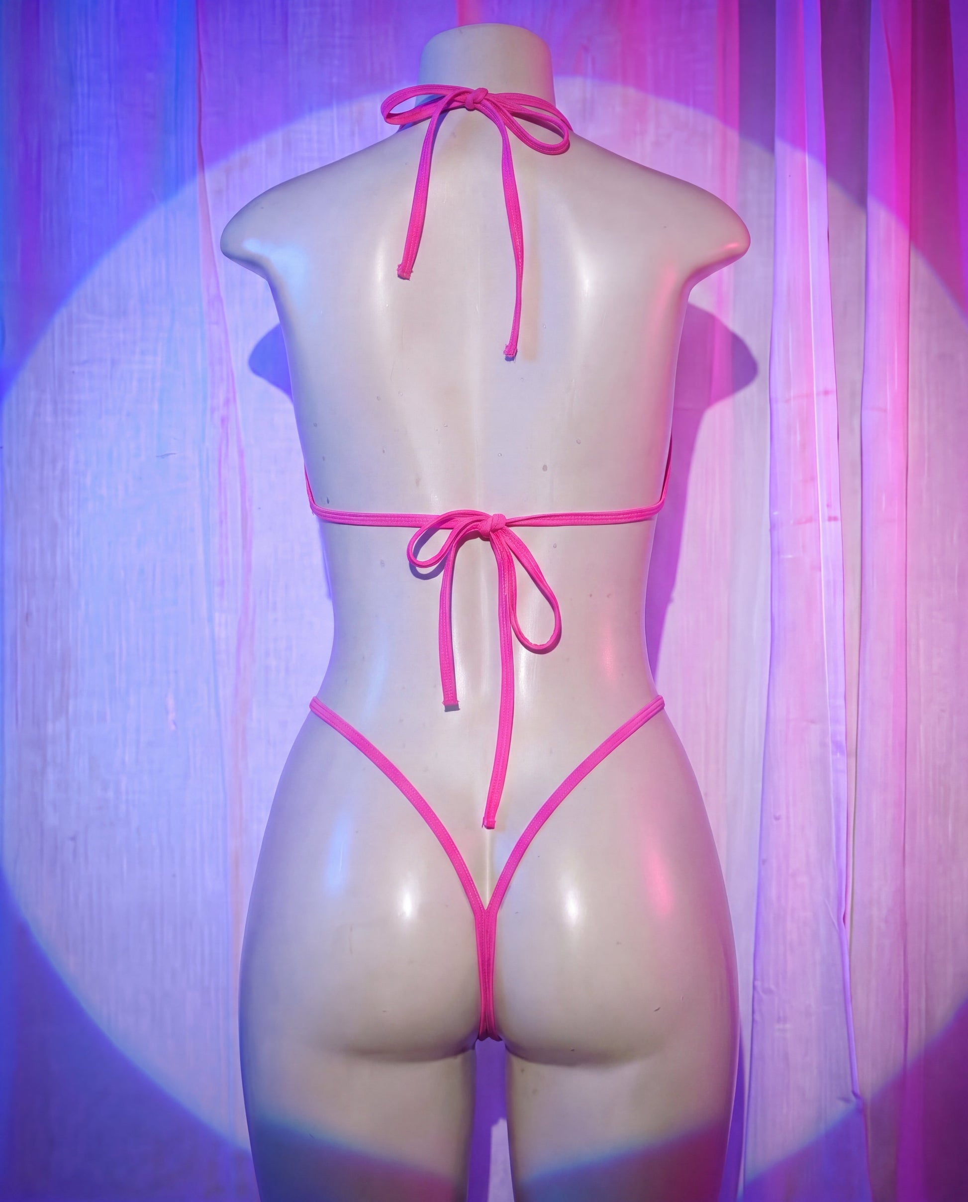 Back view of Rebel pink and black fishnet stripper bikini set with G-string thong